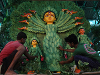 Artisans decorate an idol of the Hindu goddess Durga with eight thousand natural plants to raise awareness about global deforestation, clima...