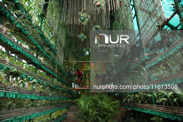 Artisans decorate an idol of the Hindu goddess Durga with eight thousand natural plants to raise awareness about global deforestation, clima...