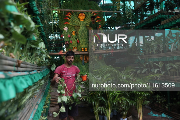 Artisans decorate an idol of the Hindu goddess Durga with eight thousand natural plants to raise awareness about global deforestation, clima...