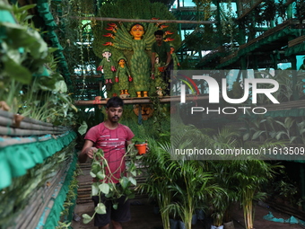 Artisans decorate an idol of the Hindu goddess Durga with eight thousand natural plants to raise awareness about global deforestation, clima...