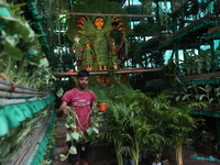 Artisans decorate an idol of the Hindu goddess Durga with eight thousand natural plants to raise awareness about global deforestation, clima...