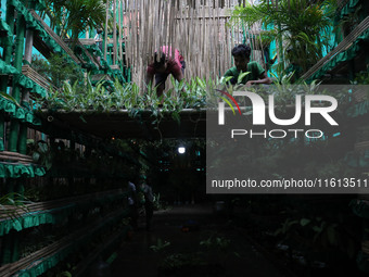 Artisans decorate a pandal with eight thousand natural plants to raise awareness about global deforestation, climate change, the importance...