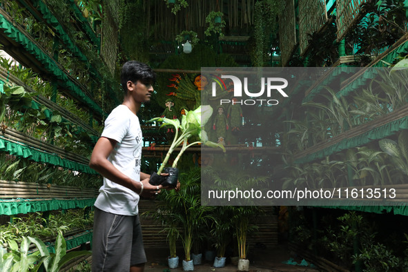 An artisan decorates a pandal with eight thousand natural plants to raise awareness about global deforestation, climate change, the importan...