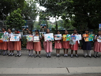 School students form a human chain and hold posters during a Global Climate Strike march in Kolkata, India, on September 27, 2024. (