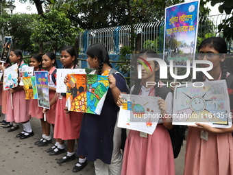 School students form a human chain and hold posters during a Global Climate Strike march in Kolkata, India, on September 27, 2024. (