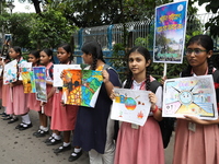 School students form a human chain and hold posters during a Global Climate Strike march in Kolkata, India, on September 27, 2024. (