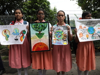 School students form a human chain and hold posters during a Global Climate Strike march in Kolkata, India, on September 27, 2024. (