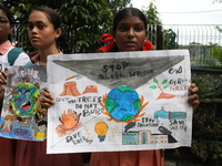 School students form a human chain and hold posters during a Global Climate Strike march in Kolkata, India, on September 27, 2024. (