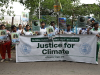 School students form a human chain and hold posters during a Global Climate Strike march in Kolkata, India, on September 27, 2024. (