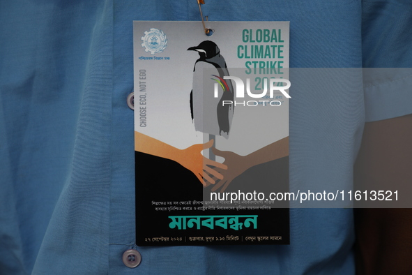 School students form a human chain and hold posters during a Global Climate Strike march in Kolkata, India, on September 27, 2024. 