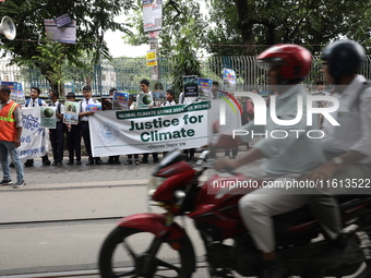 School students form a human chain and hold posters during a Global Climate Strike march in Kolkata, India, on September 27, 2024. (