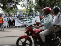 School students form a human chain and hold posters during a Global Climate Strike march in Kolkata, India, on September 27, 2024. (