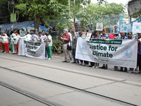 School students form a human chain and hold posters during a Global Climate Strike march in Kolkata, India, on September 27, 2024. (