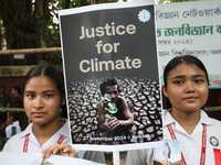 School students form a human chain and hold a poster during a Global Climate Strike march in Kolkata, India, on September 27, 2024. (