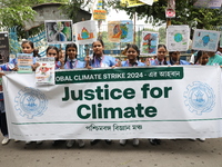 School students form a human chain and hold posters during a Global Climate Strike march in Kolkata, India, on September 27, 2024. (