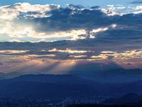 View of the morning light pouring through clouds on a distant mountain in Chongqing, China, on September 27, 2024. (