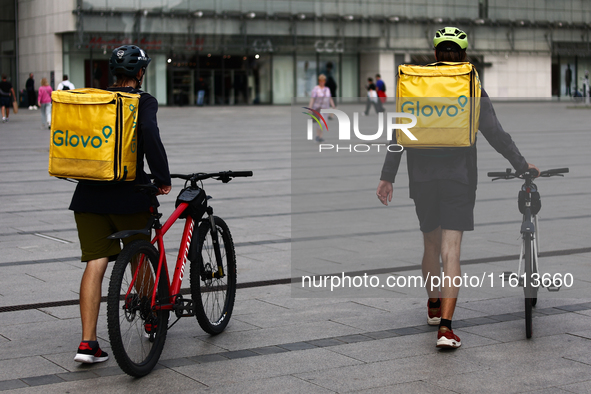 Glovo couriers are seen in Krakow, Poland on September 26, 2024. 