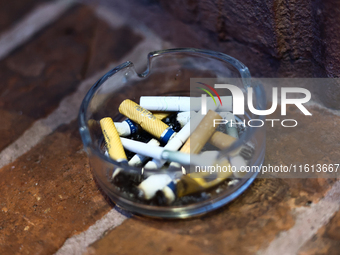 Cigarette butts are seen in the ashtray in Krakow, Poland on September 26, 2024. (