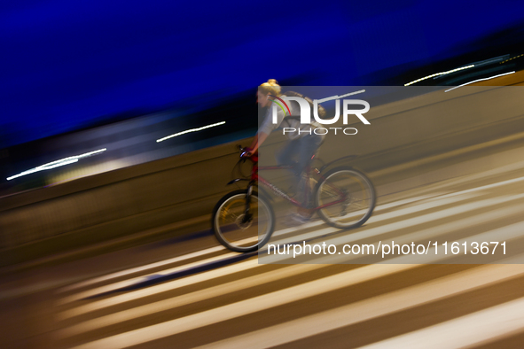 A cycler rides a bicycle in Krakow, Poland on September 26, 2024. 