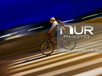 A cycler rides a bicycle in Krakow, Poland on September 26, 2024. (