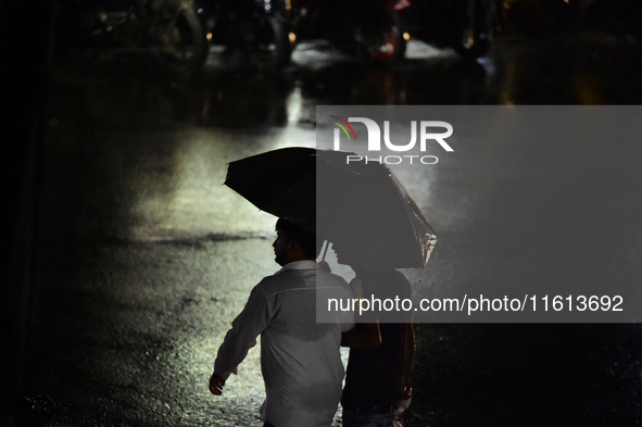 A pedestrian travels in heavy rainfall with an umbrella in Kirtipur, Kathmandu, Nepal, on September 27, 2024. 