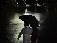 A pedestrian travels in heavy rainfall with an umbrella in Kirtipur, Kathmandu, Nepal, on September 27, 2024. (