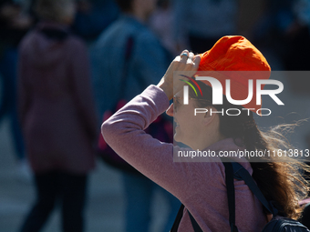 A woman struggles to walk on a windy day in Cologne, Germany, on September 27, 2024. (