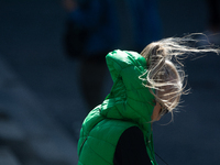 A woman struggles to walk on a windy day in Cologne, Germany, on September 27, 2024. (