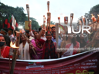 Activists of the Minority Rights Movement hold a torch march demanding justice for the attacks on the minority community in various parts of...