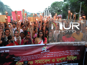 Activists of the Minority Rights Movement hold a torch march demanding justice for the attacks on the minority community in various parts of...