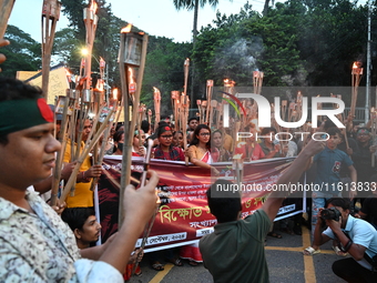 Activists of the Minority Rights Movement hold a torch march demanding justice for the attacks on the minority community in various parts of...