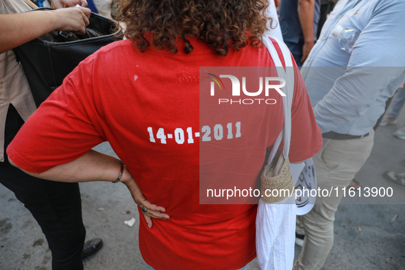 A woman wearing a T-shirt reading ''14-01-2011'' (the date of the flight of dictator Ben Ali during the Tunisian revolution) attends a demon...