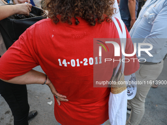 A woman wearing a T-shirt reading ''14-01-2011'' (the date of the flight of dictator Ben Ali during the Tunisian revolution) attends a demon...