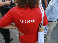 A woman wearing a T-shirt reading ''14-01-2011'' (the date of the flight of dictator Ben Ali during the Tunisian revolution) attends a demon...