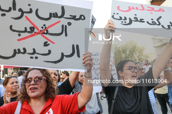 Demonstrators raise a placard that reads in Arabic, ''the parliament of the president,'' as they shout slogans during a demonstration organi...