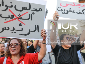 Demonstrators raise a placard that reads in Arabic, ''the parliament of the president,'' as they shout slogans during a demonstration organi...