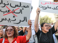 Demonstrators raise a placard that reads in Arabic, ''the parliament of the president,'' as they shout slogans during a demonstration organi...