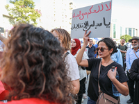 A female demonstrator raises a placard that reads in Arabic, ''No to life-long rule, Parliament of the coups,'' during a demonstration organ...