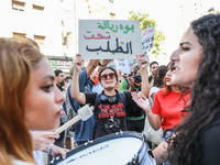 A female demonstrator raises a placard that reads in Arabic, ''President of the Parliament on demand,'' during a demonstration organized by...