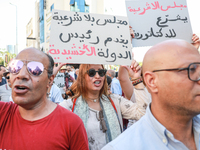 A female demonstrator shouts slogans as she raises a placard that reads in Arabic, ''a Parliament without legitimacy, at the disposal of the...