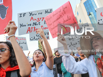 Demonstrators shout slogans and raise a placard that reads, ''If you are not angry, you are not paying attention,'' during a demonstration o...