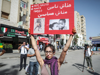 A female demonstrator holds up a placard with photos of sub-Saharan African migrants who die in the desert during a demonstration organized...