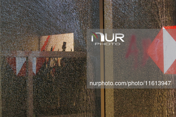 A broken door glass is seen during a protest in support of the parents of the rural student victims to demand justice during the 10th annive...