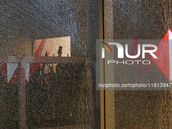 A broken door glass is seen during a protest in support of the parents of the rural student victims to demand justice during the 10th annive...