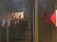 A broken door glass is seen during a protest in support of the parents of the rural student victims to demand justice during the 10th annive...