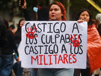 A person holds a placard while taking part in a protest in support of the parents of the rural student victims to demand justice during the...