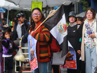 A person holds a placard while taking part in a protest in support of the parents of the rural student victims to demand justice during the...