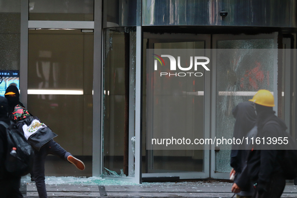 A demonstrator breaks a door glass during a protest in support of the parents of the rural student victims to demand justice during the 10th...