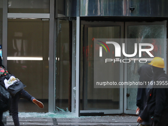 A demonstrator breaks a door glass during a protest in support of the parents of the rural student victims to demand justice during the 10th...