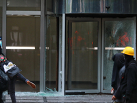 A demonstrator breaks a door glass during a protest in support of the parents of the rural student victims to demand justice during the 10th...